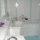 En-suite bath and shower room in white and glass mosaic tiles